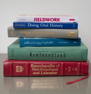 A stack of books from the reference shelves of MUNFLAs reading room